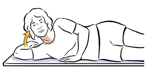 Woman lying on side doing head lift exercise.